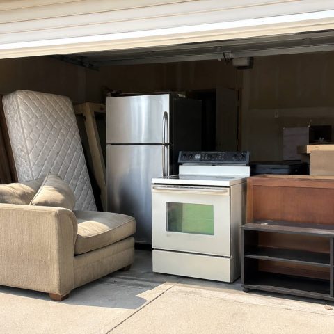 Furniture and appliance removal with old couch, mattress, refrigerator, stove, and cabinets.